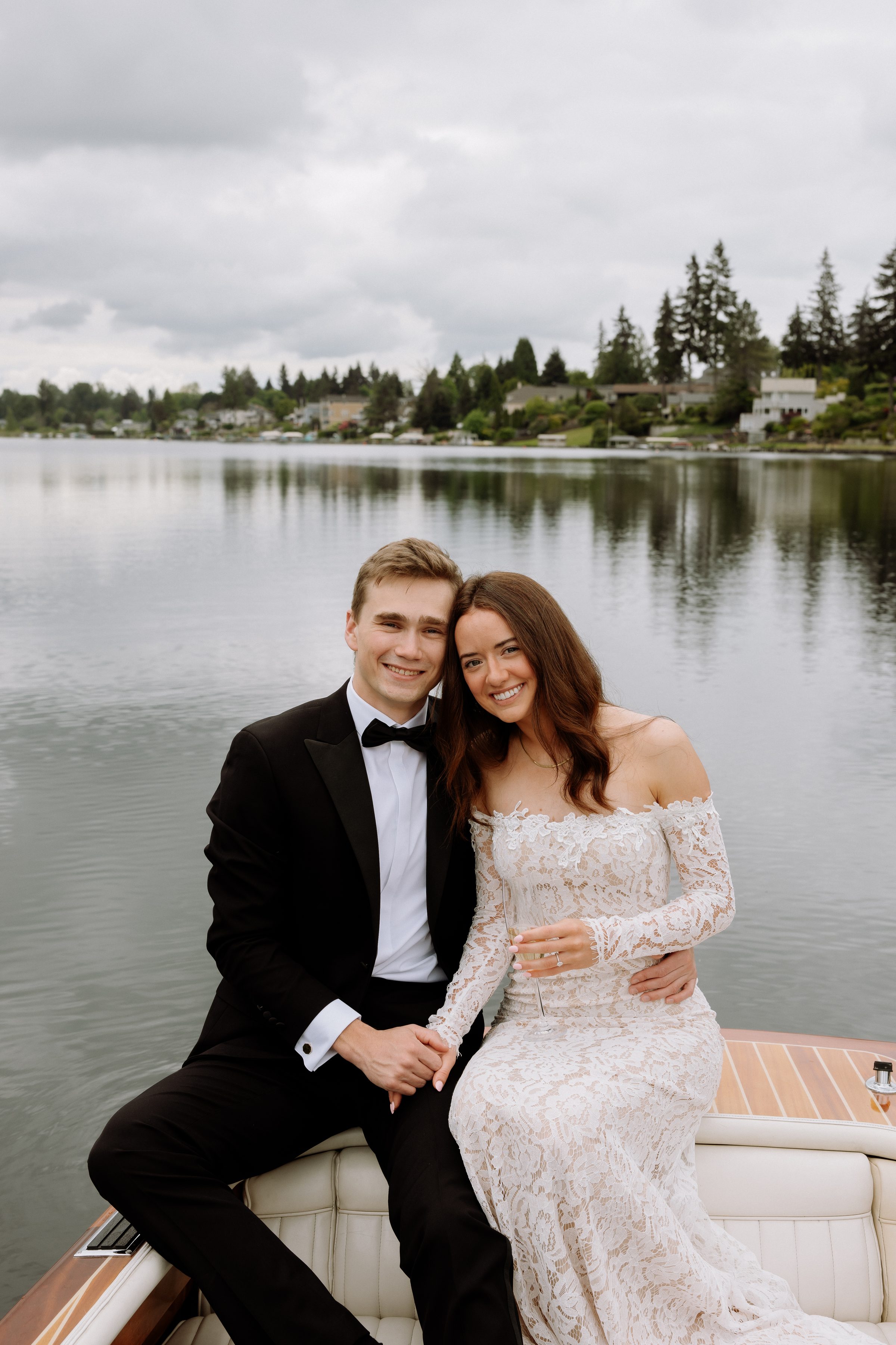Duncan and Addison smiling together on a wooden boat