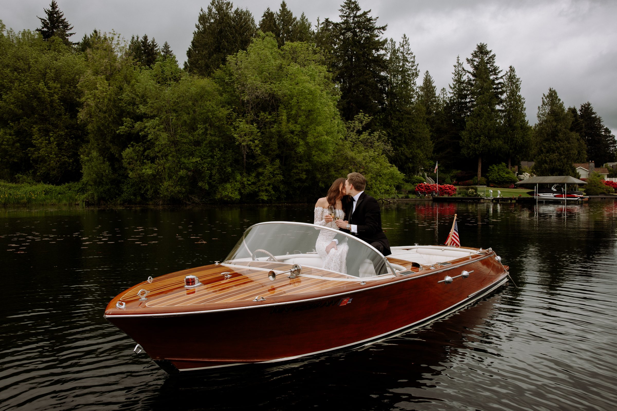 Duncan and Addison on a classic wooden boat during their engagement session